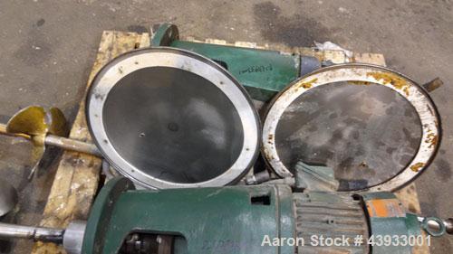 Used Tank, 1050 Gallons, 304 Stainless Steel, Vertical.  Approximately 62” diameter x 82” straight side.  Flat top, sloped bottom.  Off-center top entering Lightnin agitator, model N33G-150.  1-1/2” ...