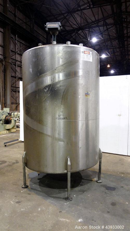 Used Tank, 1050 Gallon, 304 Stainless Steel, Vertical.  Approximately 62” diameter x 82” straight side.  Dished top, sloped bottom.  Off-center top entering Lightnin agitator, model N33G-150.  1-1/2”...