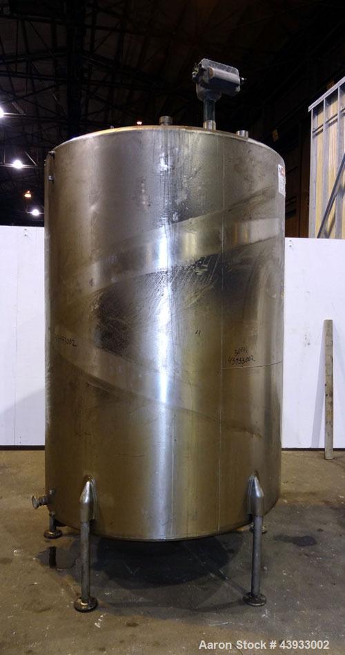 Used Tank, 1050 Gallon, 304 Stainless Steel, Vertical.  Approximately 62” diameter x 82” straight side.  Dished top, sloped bottom.  Off-center top entering Lightnin agitator, model N33G-150.  1-1/2”...