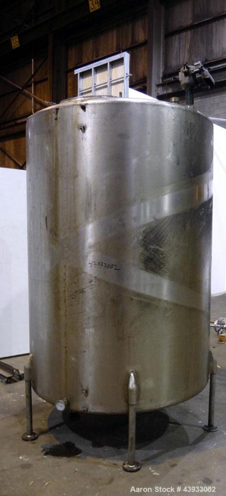 Used Tank, 1050 Gallon, 304 Stainless Steel, Vertical.  Approximately 62” diameter x 82” straight side.  Dished top, sloped bottom.  Off-center top entering Lightnin agitator, model N33G-150.  1-1/2”...