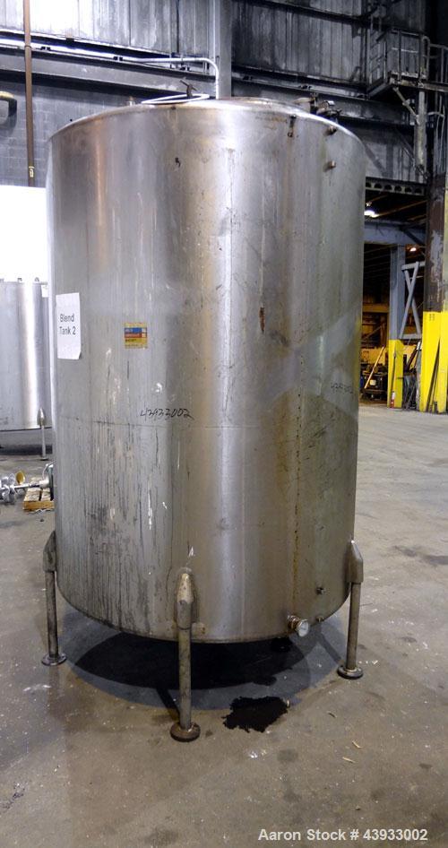 Used Tank, 1050 Gallon, 304 Stainless Steel, Vertical.  Approximately 62” diameter x 82” straight side.  Dished top, sloped bottom.  Off-center top entering Lightnin agitator, model N33G-150.  1-1/2”...