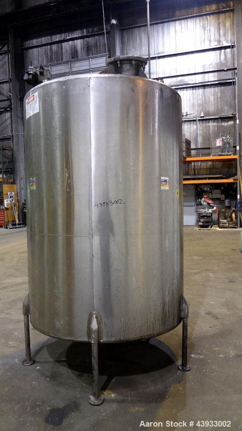 Used Tank, 1050 Gallon, 304 Stainless Steel, Vertical.  Approximately 62” diameter x 82” straight side.  Dished top, sloped bottom.  Off-center top entering Lightnin agitator, model N33G-150.  1-1/2”...