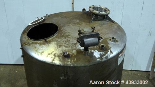 Used Tank, 1050 Gallon, 304 Stainless Steel, Vertical.  Approximately 62” diameter x 82” straight side.  Dished top, sloped bottom.  Off-center top entering Lightnin agitator, model N33G-150.  1-1/2”...