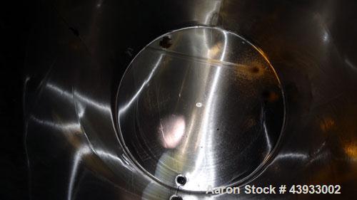 Used Tank, 1050 Gallon, 304 Stainless Steel, Vertical.  Approximately 62” diameter x 82” straight side.  Dished top, sloped bottom.  Off-center top entering Lightnin agitator, model N33G-150.  1-1/2”...