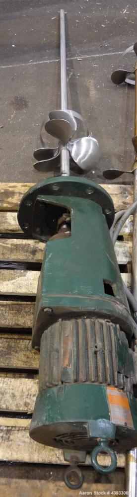 Used Tank, 1050 Gallon, 304 Stainless Steel, Vertical.  Approximately 62” diameter x 82” straight side.  Dished top, sloped bottom.  Off-center top entering Lightnin agitator, model N33G-150.  1-1/2”...