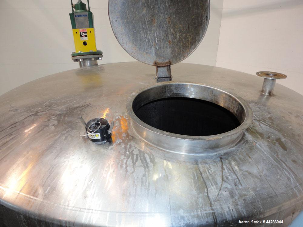 Used Tank, 2000 Gallon, 304 Stainless Steel, Vertical. 84" Diameter x 80" straight side. Dished top, coned bottom. Off center air operated Lightnin agitator, model XJAC-100, serial# R0133919201. 1-1/...