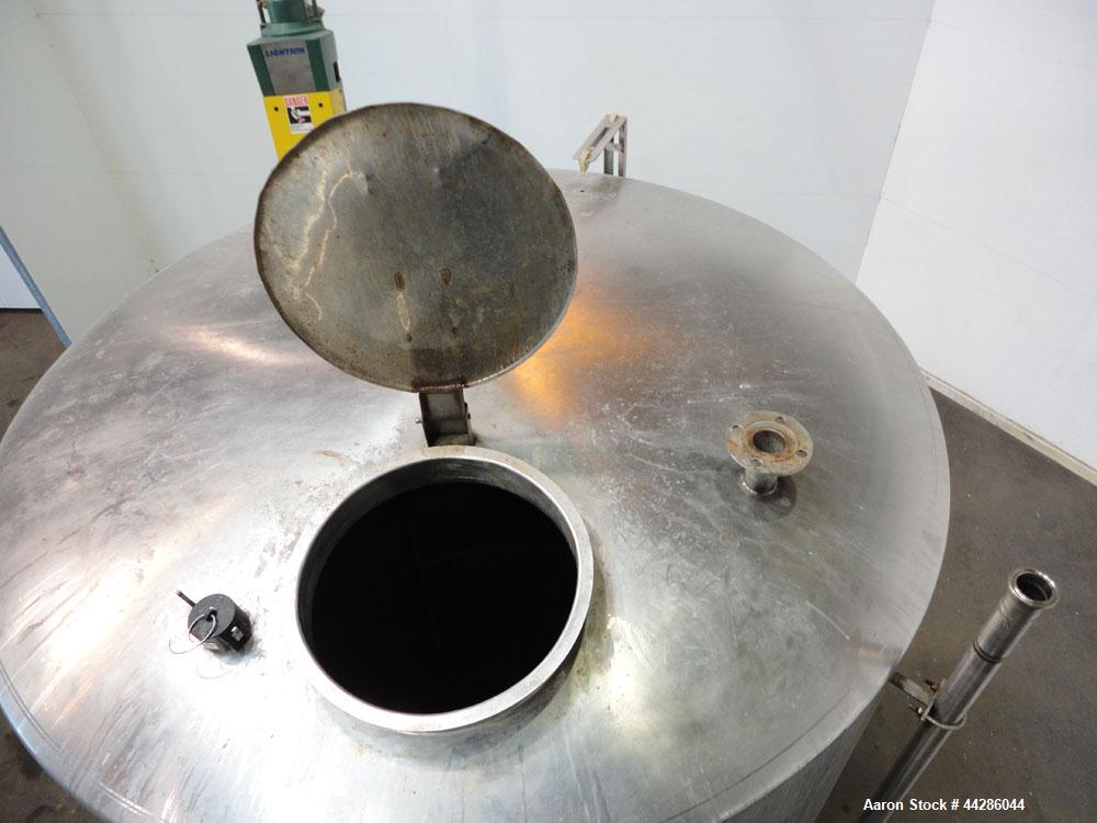 Used Tank, 2000 Gallon, 304 Stainless Steel, Vertical. 84" Diameter x 80" straight side. Dished top, coned bottom. Off center air operated Lightnin agitator, model XJAC-100, serial# R0133919201. 1-1/...