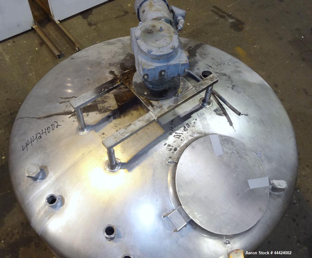 Used Tank, 1000 Gallon, 304 Stainless Steel, Vertical.  Approximately 72" diameter x 60" straight side, dished top, sloped bottom.  Fixed stainless steel agitator mount.  Approximately 2" diameter sh...