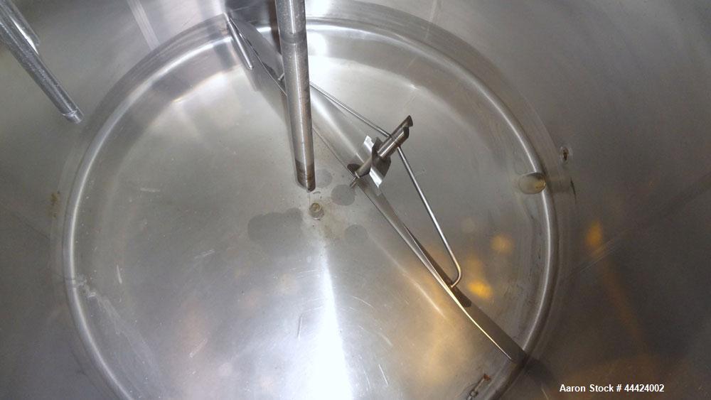 Used Tank, 1000 Gallon, 304 Stainless Steel, Vertical.  Approximately 72" diameter x 60" straight side, dished top, sloped bottom.  Fixed stainless steel agitator mount.  Approximately 2" diameter sh...