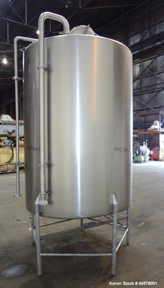 Used Tank, 1000 Gallon, 304 Stainless Steel, Vertical. 60” Diameter x 82” straight side, flat welded top, sloped bottom. Side Bottom entering agitator with a 3 blade prop, driven by a 3hp, 3/60/230/4...