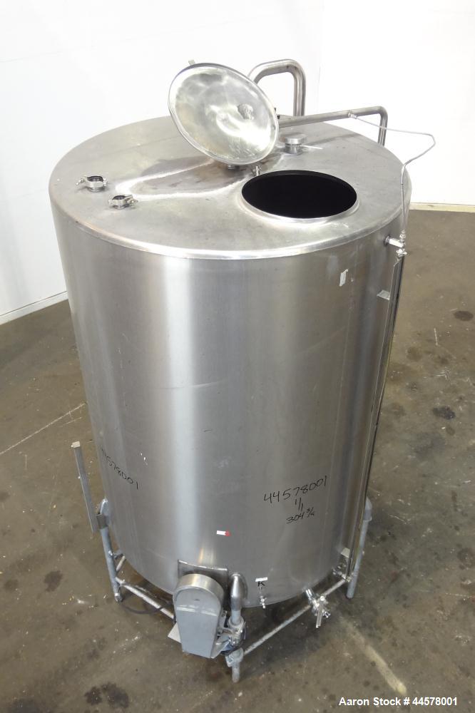 Used Tank, 1000 Gallon, 304 Stainless Steel, Vertical. 60” Diameter x 82” straight side, flat welded top, sloped bottom. Side Bottom entering agitator with a 3 blade prop, driven by a 3hp, 3/60/230/4...