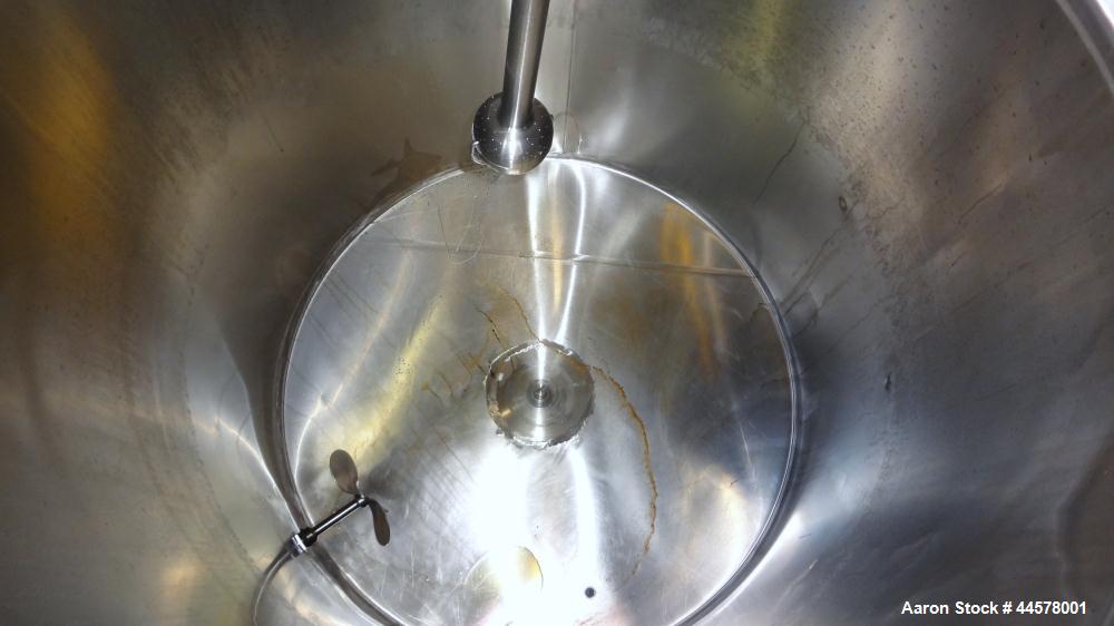 Used Tank, 1000 Gallon, 304 Stainless Steel, Vertical. 60” Diameter x 82” straight side, flat welded top, sloped bottom. Side Bottom entering agitator with a 3 blade prop, driven by a 3hp, 3/60/230/4...