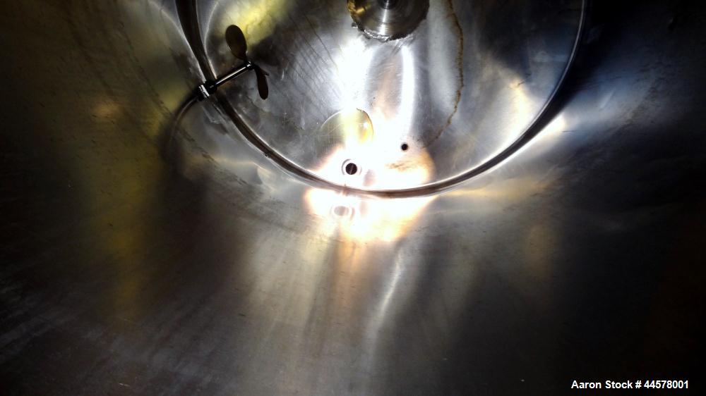 Used Tank, 1000 Gallon, 304 Stainless Steel, Vertical. 60” Diameter x 82” straight side, flat welded top, sloped bottom. Side Bottom entering agitator with a 3 blade prop, driven by a 3hp, 3/60/230/4...