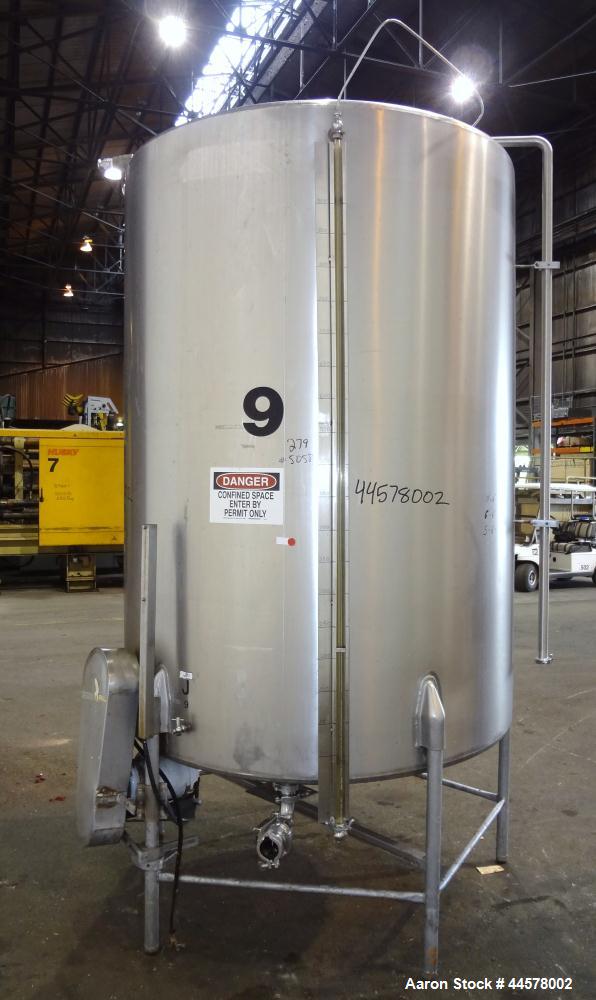 Used Tank, 1000 Gallon, 304 Stainless Steel, Vertical. 60” Diameter x 82” straight side, flat welded top, sloped bottom. Side Bottom entering agitator with a 3 blade prop, driven by a 2hp, 3/60/208-2...