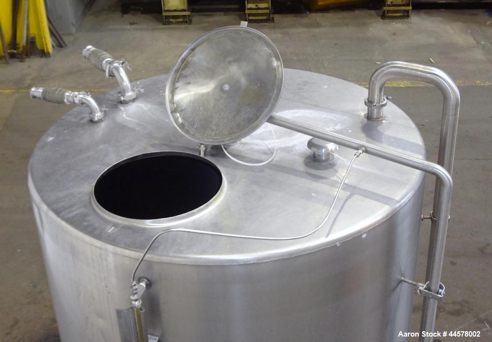 Used Tank, 1000 Gallon, 304 Stainless Steel, Vertical. 60” Diameter x 82” straight side, flat welded top, sloped bottom. Side Bottom entering agitator with a 3 blade prop, driven by a 2hp, 3/60/208-2...
