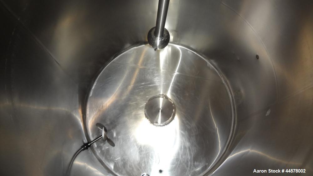 Used Tank, 1000 Gallon, 304 Stainless Steel, Vertical. 60” Diameter x 82” straight side, flat welded top, sloped bottom. Side Bottom entering agitator with a 3 blade prop, driven by a 2hp, 3/60/208-2...