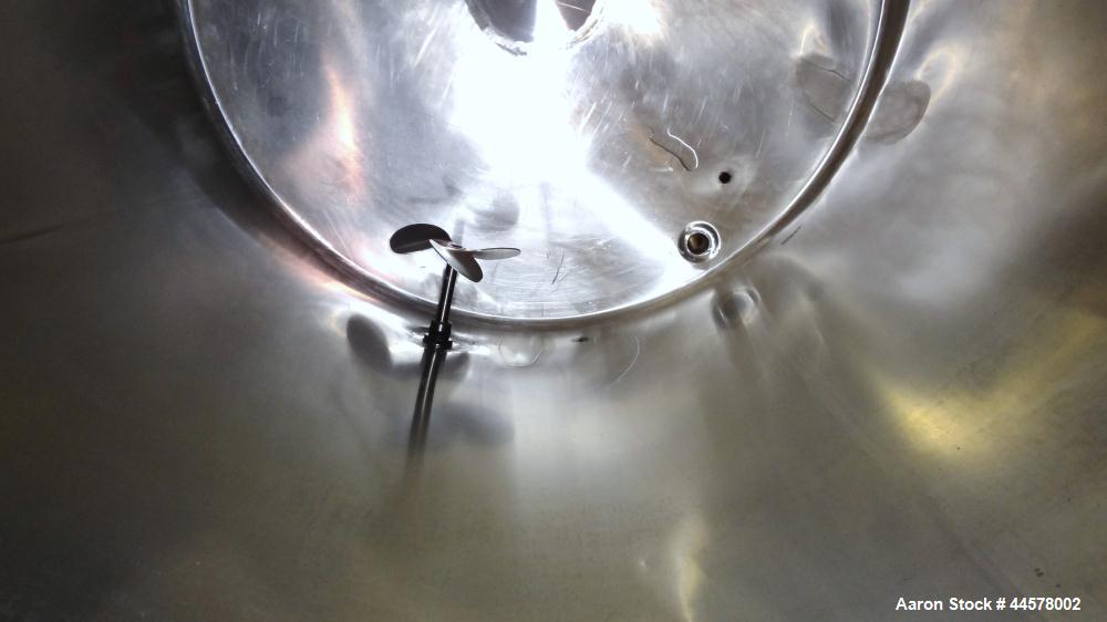 Used Tank, 1000 Gallon, 304 Stainless Steel, Vertical. 60” Diameter x 82” straight side, flat welded top, sloped bottom. Side Bottom entering agitator with a 3 blade prop, driven by a 2hp, 3/60/208-2...