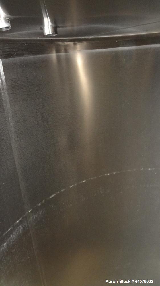 Used Tank, 1000 Gallon, 304 Stainless Steel, Vertical. 60” Diameter x 82” straight side, flat welded top, sloped bottom. Side Bottom entering agitator with a 3 blade prop, driven by a 2hp, 3/60/208-2...