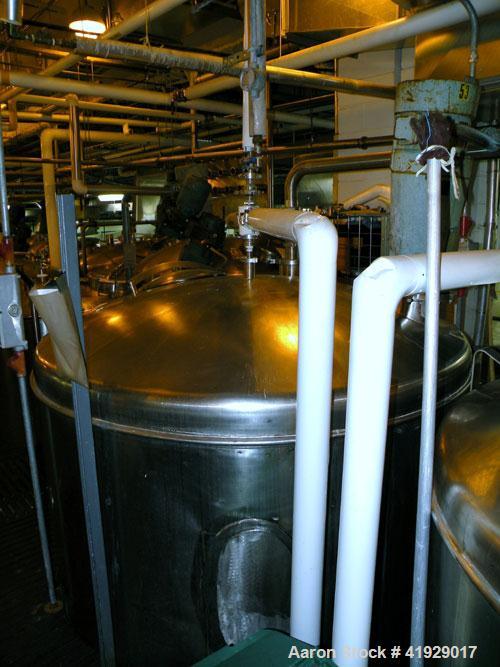 Used Norwalk Tank, 2000 Gallon,  stainless steel, vertical. 76" diameter x 106" straight side, dished top and bottom. Off center top entering angled Lightnin agitator, model N33G-300. 1-1/2" diameter...
