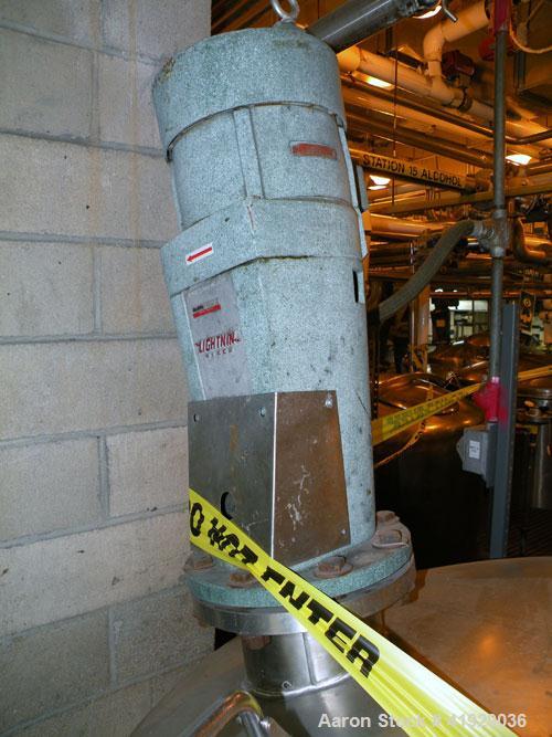 Used Norwalk Tank, 2000 Gallon,  Stainless Steel, Vertical. 76" diameter x 106" straight side, dished top and bottom. Off center top entering Lightnin agitator, model N33G-300. Driven by a 3hp, 3/60/...