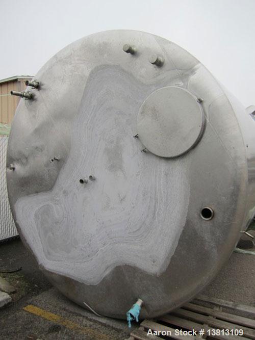 Used Sani Tank Stainless Steel Mixing Tank, 4,000 Gallons.  Side agitated, stainless steel, side and top manways.  Slope bottom with 3" bottom discharge, 5 top inlets:  2.5", 3", 1.5", 2.5".  102" Di...
