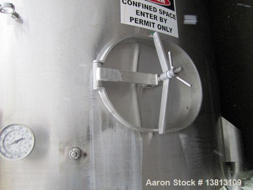 Used Sani Tank Stainless Steel Mixing Tank, 4,000 Gallons.  Side agitated, stainless steel, side and top manways.  Slope bottom with 3" bottom discharge, 5 top inlets:  2.5", 3", 1.5", 2.5".  102" Di...