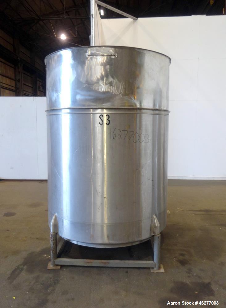 Used Tank, Approximately 1,000 Gallons, 304 Stainless Steel, Vertical. Approximately 62" diameter x 79" straight side. Flat top, sloped bottom. 1-1/2" Off-center bottom outlet. Mounted on (4) legs.