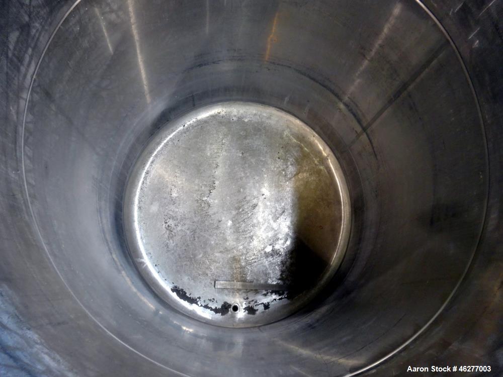 Used Tank, Approximately 1,000 Gallons, 304 Stainless Steel, Vertical. Approximately 62" diameter x 79" straight side. Flat top, sloped bottom. 1-1/2" Off-center bottom outlet. Mounted on (4) legs.