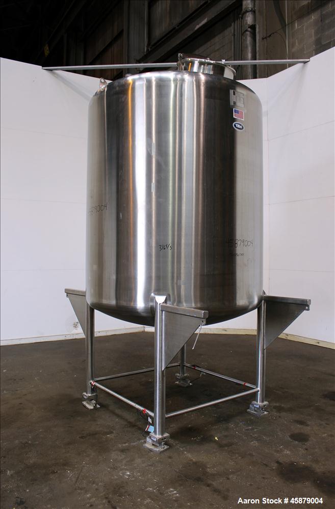 Used T&C Stainless Tank, 1,000 Gallon, 316L Stainless Steel, Vertical. Approximately 65" diameter x 70" straight side. Dished top and bottom. Internal rated 5.25 psi at 250 degrees F. Top opening: 19...