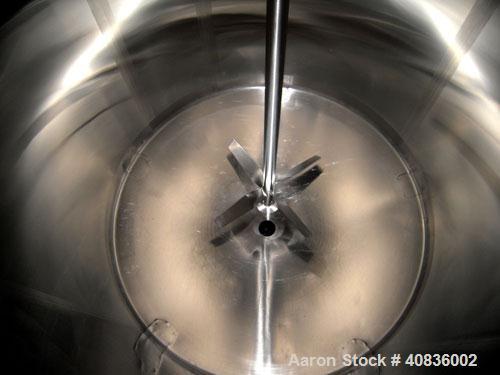 Used Walker Stainless Tank, 1000 gallon, 316 stainless steel, vertical. 66" diameter x 72" straight side, dished top, coned bottom.  Off center top entering agitator, 2" diameter bottom supported sha...