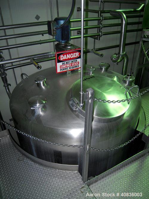 Used Walker Stainless Tank, 1000 gallon, 316 stainless steel, vertical. 66" diameter x 72" straight side, dished top, coned bottom. Off center top entering agitator, 2" diameter bottom supported shaf...