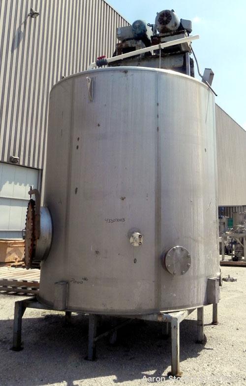 Used Walker Stainless Tank, 4700 Gallon, 304 Stainless Steel, Vertical. Approximate 108” diameter x 120” straight side, coned top, flat bottom. Top entering agitator, with an anchor style blade with ...