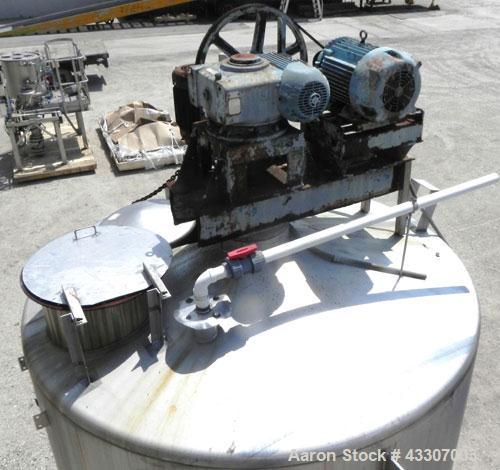 Used Walker Stainless Tank, 4700 Gallon, 304 Stainless Steel, Vertical. Approximate 108” diameter x 120” straight side, coned top, flat bottom. Top entering agitator, with an anchor style blade with ...