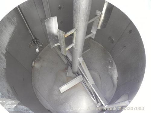 Used Walker Stainless Tank, 4700 Gallon, 304 Stainless Steel, Vertical. Approximate 108” diameter x 120” straight side, coned top, flat bottom. Top entering agitator, with an anchor style blade with ...