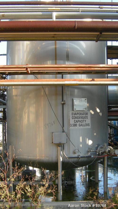 USED: Walker 3,500 gallon, type 304L stainless steel, storage tank. Vertical, dished heads. Approximate 8' diameter x 10' straight side. Misc top and side flanged openings. Side openings include an 1...
