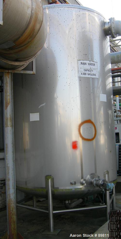 USED: Walker 4,800 gallon, type 304L stainless steel, storage tank. Vertical, dished heads. Approximate 8' diameter x 12' straight side. Misc top and side flanged openings. Side openings include a 16...