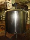 Used DCI 1000 gallon single wall vertical mixing tank. 6' diameter x 5' straightwall x 10' overall height. (4) stainless steel legs, sight glass, (3) 4