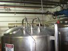 Used DCI 1000 gallon single wall vertical mixing tank. 6' diameter x 5' straightwall x 10' overall height. (4) stainless steel legs, sight glass, (3) 4
