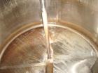 Used DCI 1000 gallon single wall vertical mixing tank. 6' diameter x 5' straightwall x 10' overall height. (4) stainless steel legs, sight glass, (3) 4