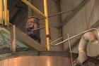 Used Approximate 4750 gallon Stainless Steel Agitated Tank With 5 HP Centrifugal Pump, V-4781. Top entering agitator (HP unknown). Cone bottom with center bottom outlet. Side bottom manway.