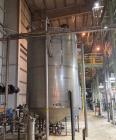 Used Approximate 4000 gallon Stainless Steel Storage Tank With 7.5 HP Centrifugal Pump, V-4782.  Misc. top inlets. Cone bottom with center bottom outlet. Bottom side manway. With 7.5 HP stainless ste...