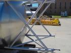Unused 2,000 Gallon Vertical Stainless Steel Agitated Tank. Dished top and bottom. Stainless steel top agitator bridge with counter rotating side scrape agitation. Top manway. Center bottom outlet. M...