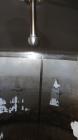 Used Cherry Burrell Tank, 2000 Gallon, 304 Stainless Steel, Vertical. 84” Diameter x 81” straight side, dished top, sloped bottom. (1) Spray ball, external side ladder. Openings: top (2) 2”, 3”, 3