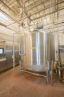 Used DCI 2,000 Gallon Stainless Steel Single Wall Mix Tank, Vertical. Dome Top/Cone Bottom. Top mounted agitation with bottom sweep blade and motor. Top entering baffle. Dual CIP Spray Ball. Mounted ...
