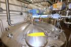 Used DCI 2,000 Gallon Stainless Steel Single Wall Mix Tank, Vertical. Dome Top/Cone Bottom. Top mounted agitation with bottom sweep blade and motor. Top entering baffle. Dual CIP Spray Ball. Mounted ...