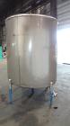 Used Mueller Tank, 1000 Gallons, 304 Stainless Steel, Vertical. 67” Diameter x 70” straight side, Open top with (2) covers, sloped bottom. Side bottom entering agitator with (3) blade prop driven by ...