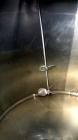 Used Mueller Tank, 1000 Gallon, 316 Stainless Steel, Vertical. Approximate 76” diameter x 57” straight side, open top with (2) covers, sloped bottom. (2) Lightnin clamp on agitators. (1) Model XJ-65V...
