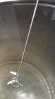 Used Mueller Tank, 1000 Gallon, 316 Stainless Steel, Vertical. Approximate 76” diameter x 57” straight side, open top with (2) covers, sloped bottom. (2) Lightnin clamp on agitators. (1) Model XJ-65V...