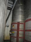USED APPROXIMATELY 3,400 GALLON VERTICAL STAINLESS STEEL TANK. 6'8