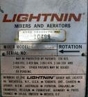Used Tank, 2000 Gallon, 304 Stainless Steel Vertical. 84” Diameter x 80” straight side. Dished top, coned bottom. Off center top entering Lightnin air operated agitator, model N33AG-100. 1-1/2” Diame...